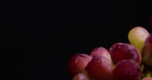 Video of red grapes on black background with 4K dolly and stop.
Shot on a black reflective background.