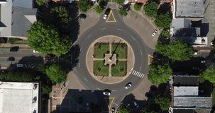 Public square with roundabout in downtown Franklin, Tennessee with cars driving. Drone video.