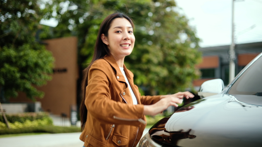 Surprised young asian woman getting the new car. She hugged his car and was very happy. Buy or rent car concept. Royalty-Free Stock Footage #1091118905