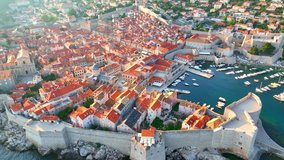 flying above Dubrovnik old town at sunset, aerial view of historic city of Dubrovnik in Croatia, UNESCO World Heritage site in Croatia, famous tourist attraction in the Mediterranean. 