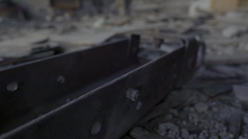 The ruins in which the toy lies, the consequences of the war, the destroyed building, the remains of toys, the war, the consequences of the fire