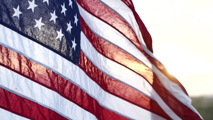 American USA flag waving in the wind against sunset in nature outdoor background. Concept of 4th of July, Memorial Day, Independence Day, Veterans Day, American Celebration, Patriots, Labor, President | Shutterstock HD Video #1091127609