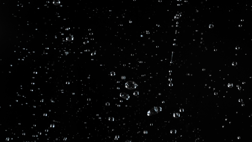 Super slow motion of realistic rain shower on black background. Filmed on high speed cinema camera, 1000 fps. Royalty-Free Stock Footage #1091128195