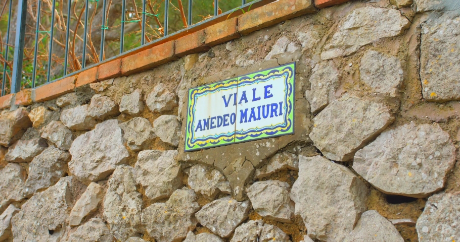 Typical Street Sign On Cobblestone Wall In Capri, Italy. - panning