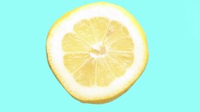 Lemon close-up rotates cyclically on a highlighted blue background. Healthy food and fresh fruit. Refreshing, delicious, lemon fruit