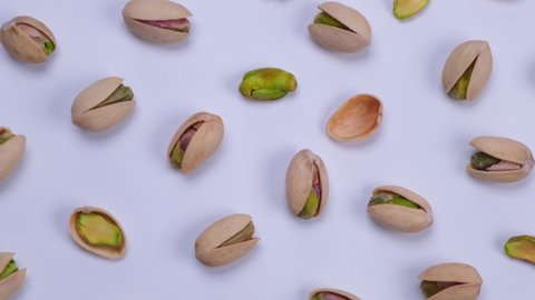 Rotating pistachios on a white background close-up