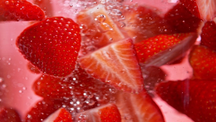 Super Slow Motion Shot of Fresh Strawberries Falling into Water Vortex at 1000 fps. Royalty-Free Stock Footage #1091133857