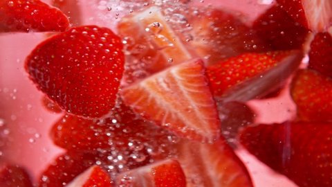Super Slow Motion Shot of Fresh Strawberries Falling into Water Vortex at 1000 fps. Video Stok
