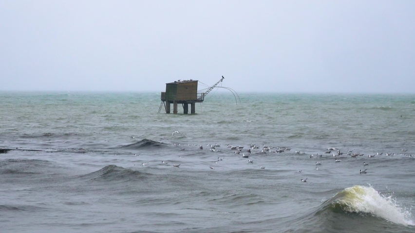 Typical fishing hut in the ocean during storm with rain. Brittany France, French Atlantic coast