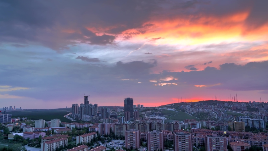 8K 7680X4320 4320p.Evening sky in the city towards at red sunset.Afternoon through skyscrapers.Time lapse buildings in a new modern Lahore Pakistan.Cityscape silhouette background cinematic landscape