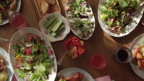 Dining table with various salads, top view. Time for a family dinner at the table with delicious dishes. High quality 4k footage