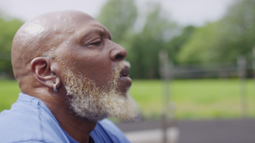 Close portrait of senior black male getting his breath back and recovering after a workout session Royalty-Free Stock Footage #1091141689