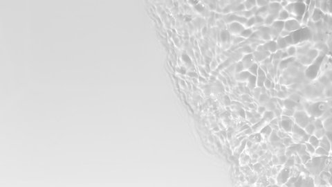 Close up view on Water texture with waves and light reflections. Water overlay effect for video mockup. Organic light gray drop shadow caustic effect with wave refraction of light. Slow motion full HD