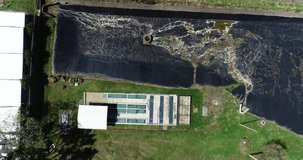 aerial video of wastewater treatment plant, residential retention lagoon