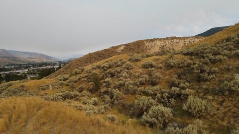The expansive, dry landscape of the Okanagan region in British Columbia Canada. Wide angle ascending fly over view