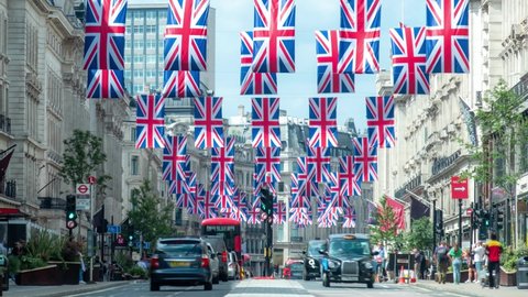 London- June 2022: Time lapse of Regent Street in London's West End with rows of British flags 