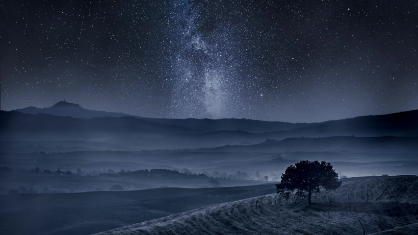 Timelapse of dreamland in Tuscany with tree on field and milky way