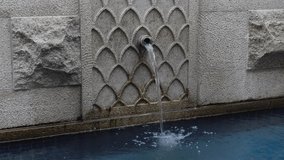Modern concrete water fountain with beautiful space. A concrete water fountain on a sunny day. water fountain static shot closeup view. 4K video.