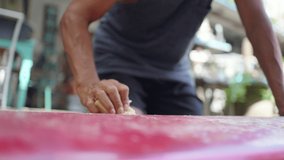 Healthy Asian senior man waxing surfboard surface at home. Active elderly male surfer enjoy outdoor lifestyle surfing at the sea on summer vacation. Retirement people activity and water sport concept. - Powered by Shutterstock - Get 15% off with code: PIKWIZARD15