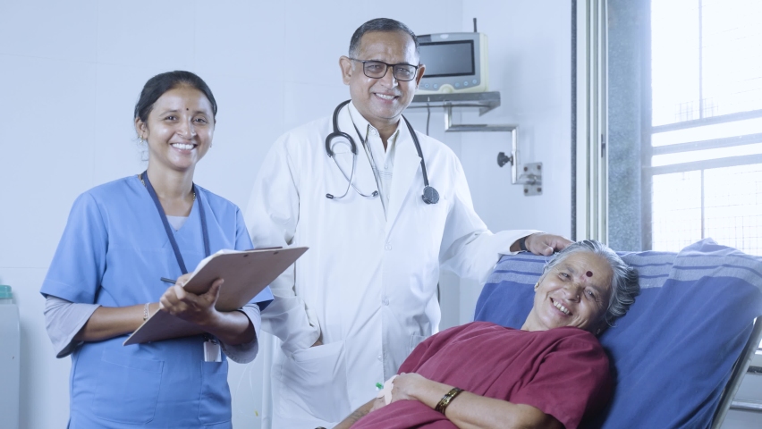 Happy smiling doctor, patient and nurse looking at camera during ward visit at hospital - concept of recovery, medicare and treatment. | Shutterstock HD Video #1091155015