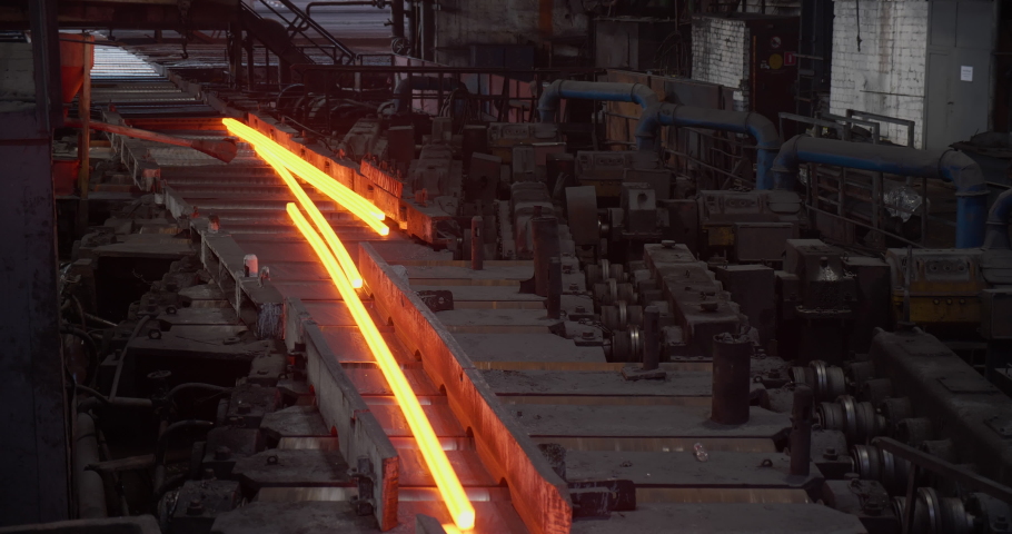 Hot steel rail on a conveyor in a metallurgical plant. Rolling shop. Business concept, modern steel production technology
