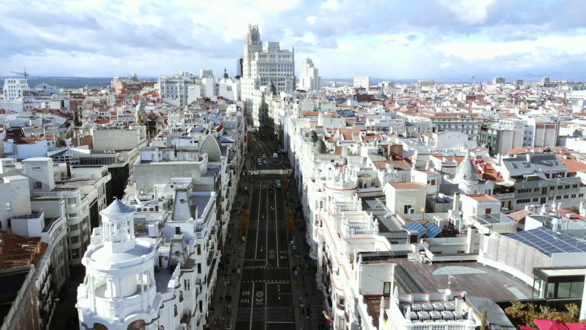 Aerial scene of Madrid with car traffic on Gran Via street, Spain. Urban architecture with high office building and densely built-up residential quarters Royalty-Free Stock Footage #1091158355