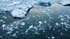 Icebergs from melting glacier in Jokulsarlon lagoon in Iceland, Arctic nature ice landscape in Unesco World Heritage Site, Drone aerial video top view - Climate Change and Global Warming