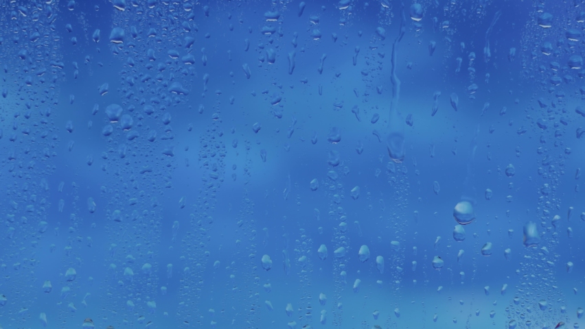 View from the window in rainy weather, raindrops on the window dripping down, autumn season, monsoon time, slow motion, 8K downscale, 4K.