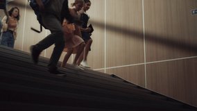 Group of teenagers running downstairs dark school corridor. Children legs stepping on stairway close up. Energetic happy schoolchildren going down stairs. Diverse pupils rushing together after classes - Powered by Shutterstock - Get 15% off with code: PIKWIZARD15