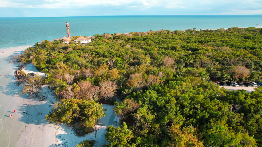 Panorama of Sanibel island in Lee County FL. Florida beach. Lighthouse. Spring or Summer vacations in USA. Blue-turquoise color of salt water. Ocean or Gulf of Mexico. Tropical Nature. Aerial view.