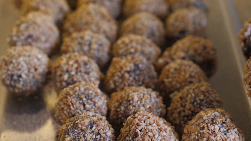 Close-up of freshly made homemade chocolate bowls with nuts on the top. Shopping shelf