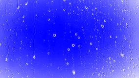 Rain water drops on blue background on 4K animation stock footage. Falling Rain Drops In Close View.