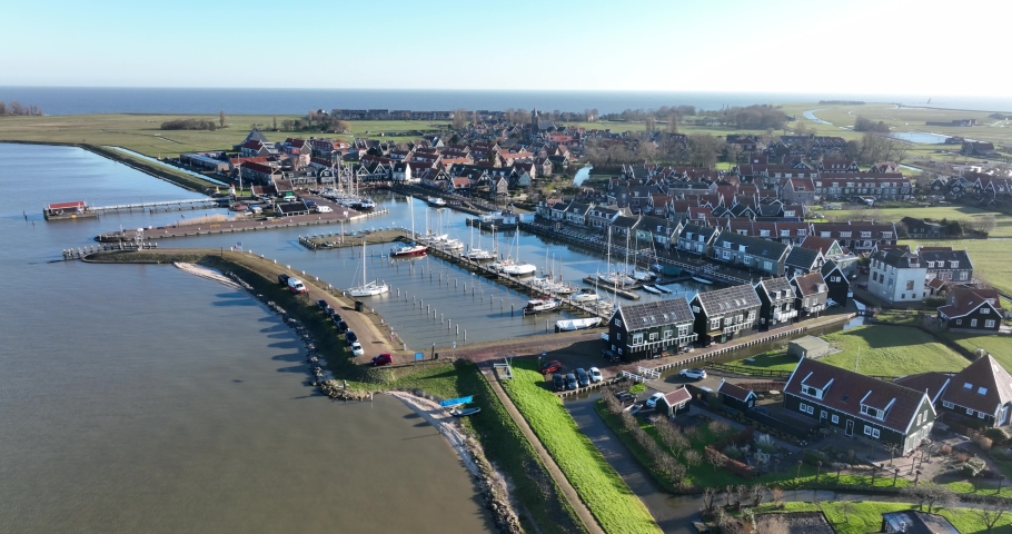 Peninsula Marken in the municipality of Waterland harbour. Old dutch historic fishing village in the Markermeer. European dutch culture, old wooden houses. Touristic attraction. Royalty-Free Stock Footage #1091172175
