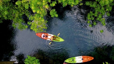 couple in a kayak in the jungle of Krabi Thailand, men and woman in kayak at a tropical jungle in Krabi mangrove forest. 