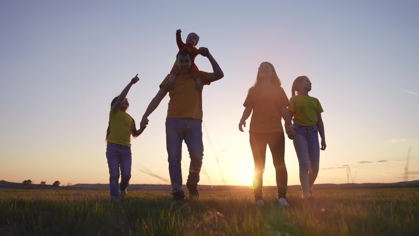 people in the park. happy family walking together in the park silhouette. friendly family kid freedom concept. happy family walking holding hands in the park sunset on the grass. friendly family sun Royalty-Free Stock Footage #1091177145