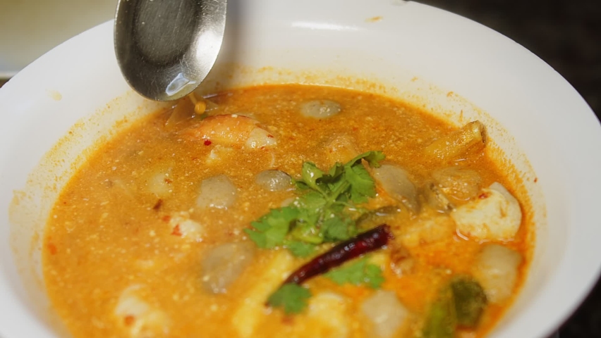 Close up Thai style hot and spicy food tom yum Goong soup with shrimp River prawn and ingredients in bowl , famous Thai food Tom Yum Goong is popular Thai cuisine served in Thai restaurant Royalty-Free Stock Footage #1091179913