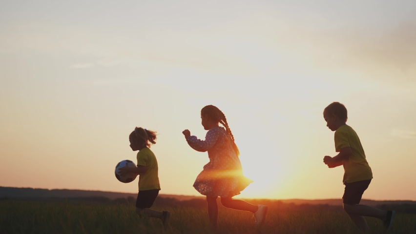 crowd of kids run. people in the park. happy family kid dream concept. brother sister little children holding a ball silhouette run across the field at sunset. fun happy family kids Royalty-Free Stock Footage #1091180641