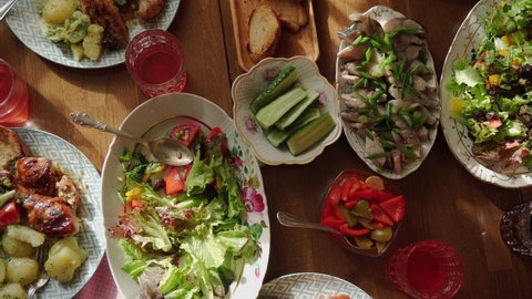 Dining table with various salads, top view. Time for a family dinner at the table with delicious dishes. High quality 4k footage