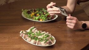 Female hands take pictures of plates of food on the table using a modern smartphone. High quality 4k footage