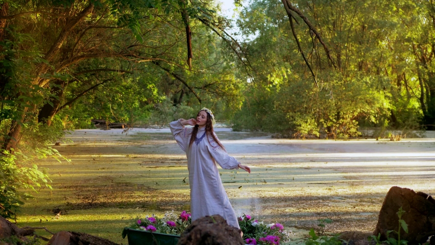 Beautiful girl in a boat. Young woman posing in a boat on the river. Lake in the woods.
