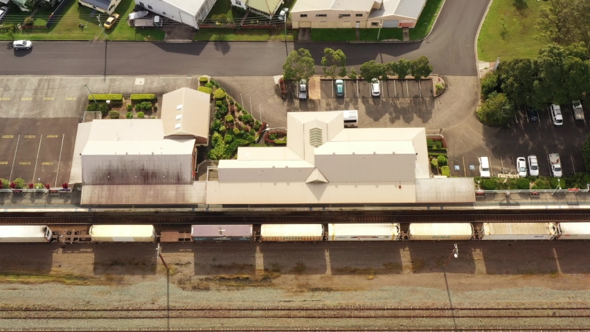 Train station railway tracks in Taree regional rural city of Australia – aerial 4k.
