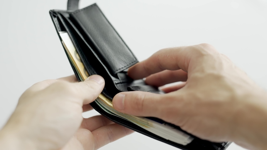 A man hands are counting euro bill notes. A lot of cash. Money in the wallet. Concept of finance profit or wealth and win. Close up.