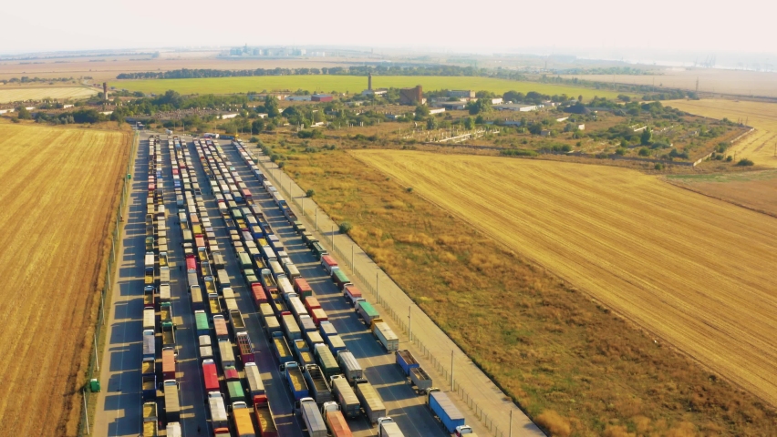 A huge queue of trucks loaded with grain crops in a blocked Ukrainian port. Humanitarian crisis due to the war. Royalty-Free Stock Footage #1091192129