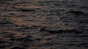 4k stock video footage of abstract nature liquid background. Gradient natural colors of dramatic sunset blue sea waves. Brown sunset sea water backdrop