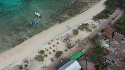aerial top down of white sand beach bar on Gili Meno Island with turquoise water