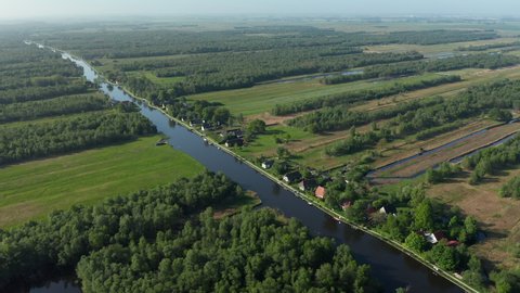 Scenic View Of River Watercourse In Dense Forestland In Ossenzijl, Friesland, Netherlands. Aerial Wide Shot
