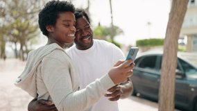 African american man and woman couple having video call at street