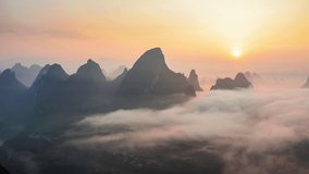 Aerial footage of Beautiful mountain and clouds with fog natural landscape at sunrise in Guilin, China. 4k real time footage.