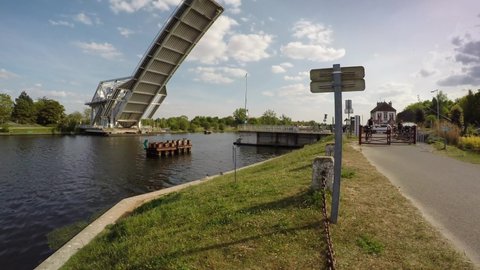 Caen, France May 2022. Opening timelapse of the Pegasus Bridge and the passing large cruise liner LE DUMONT DURVILLE departing the port from Caen towards Ouistreham.