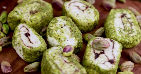 fresh Turkish delight with crushed pistachios and chocolate, spinning on the boards fresh Turkish delight from a wooden board